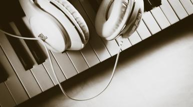 headphones on a piano, b/w